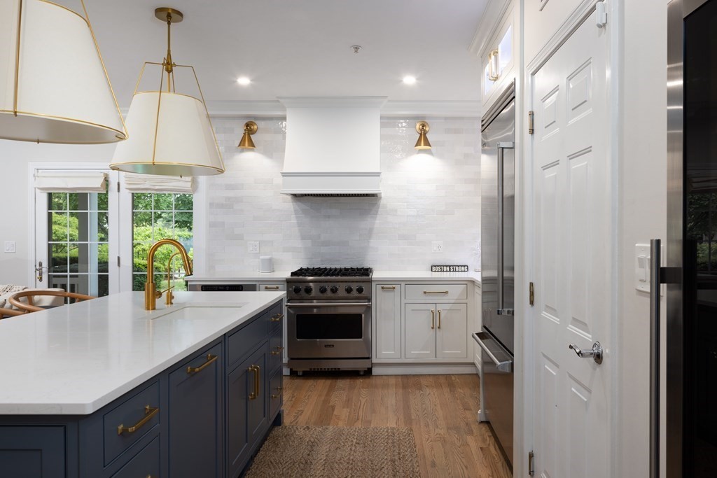 209 Victory Road, Unit 209 Quincy, MA 02171 - Photo 1 of 17 a kitchen with a sink stainless steel appliances and cabinets