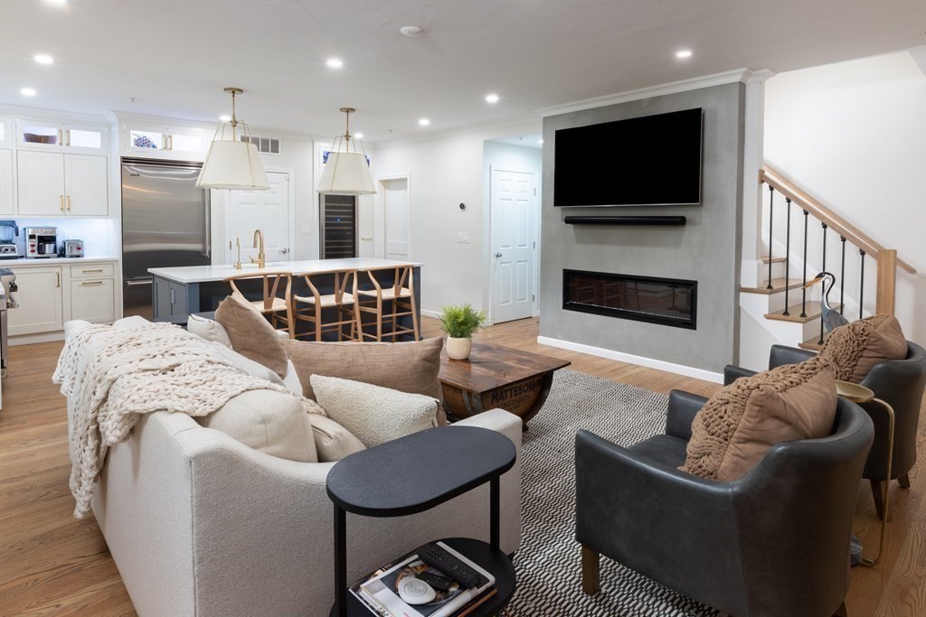 209 Victory Road, Unit 209 Quincy, MA 02171 - Photo 2 of 17 a living room with furniture and a flat screen tv