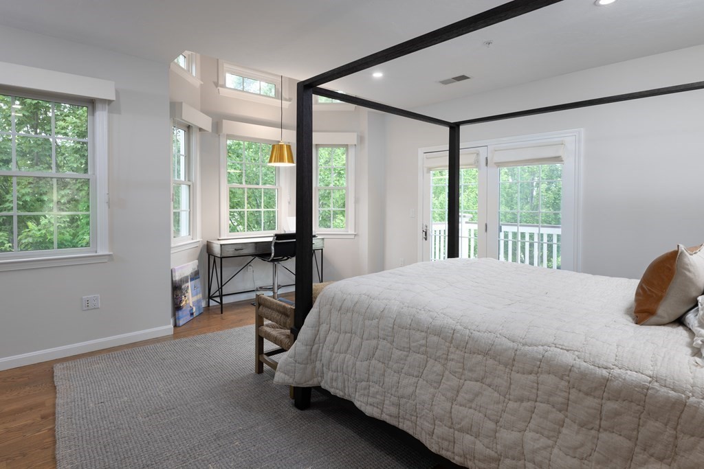 209 Victory Road, Unit 209 Quincy, MA 02171 - Photo 5 of 17 a bedroom with a bed chair and a large window