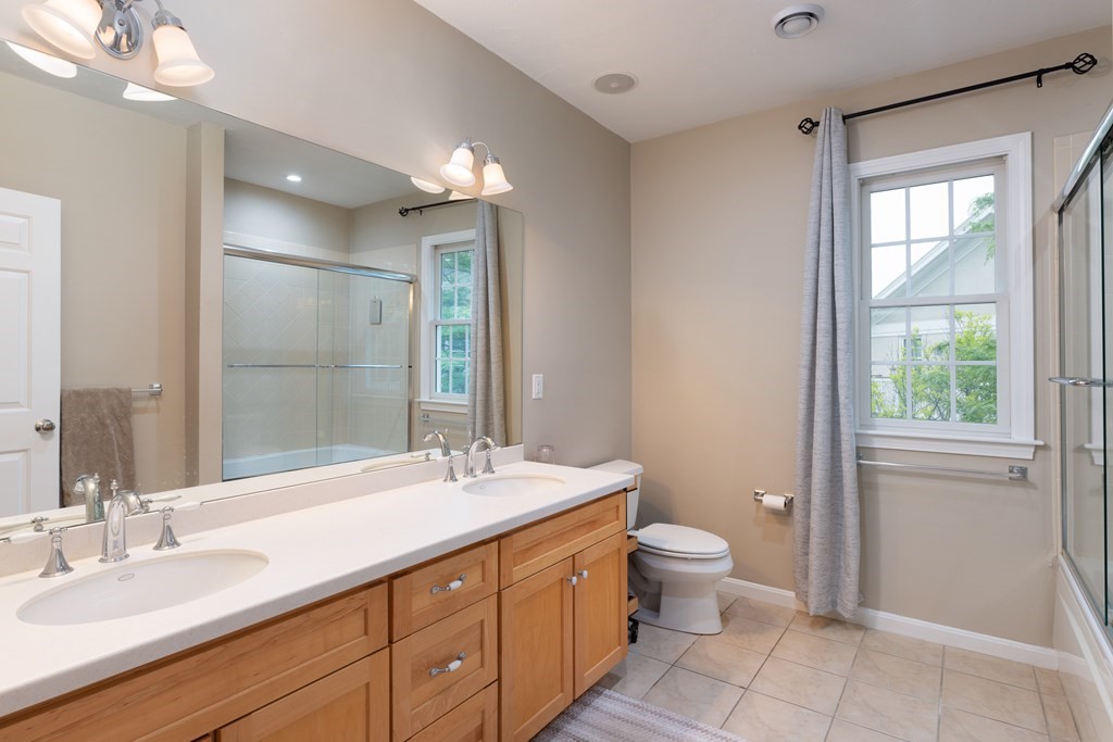 209 Victory Road, Unit 209 Quincy, MA 02171 - Photo 7 of 17 a spacious bathroom with a double vanity sink toilet and a mirror
