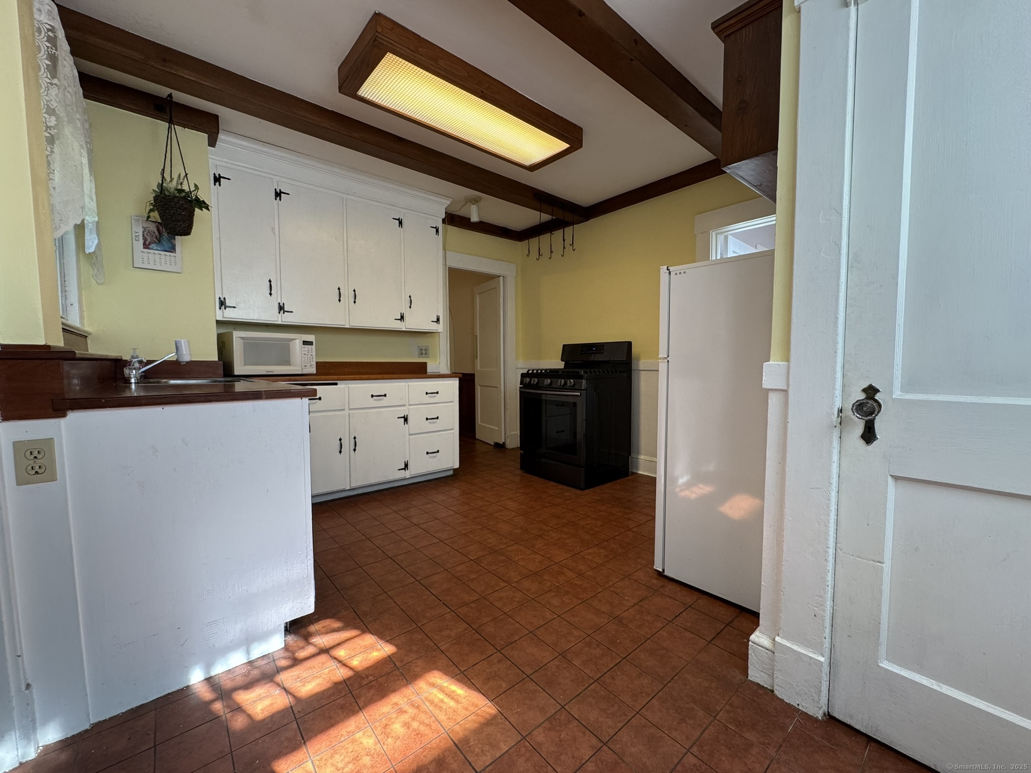 16 Park Place Meriden, CT 06451 - Photo 5 of 30 a kitchen with a refrigerator and a stove