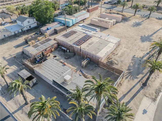 an aerial view of a house with open space and trees