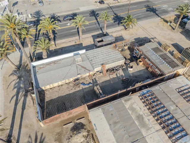 an aerial view of a house with a yard and seating area