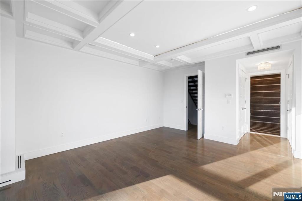 12 Orchard Street, Unit 12 Edgewater, NJ 07020 - Photo 20 of 33 an empty room with wooden floor and windows
