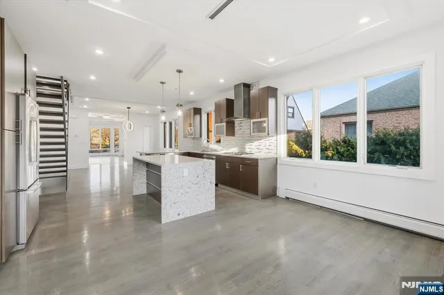 a large white kitchen with a large window