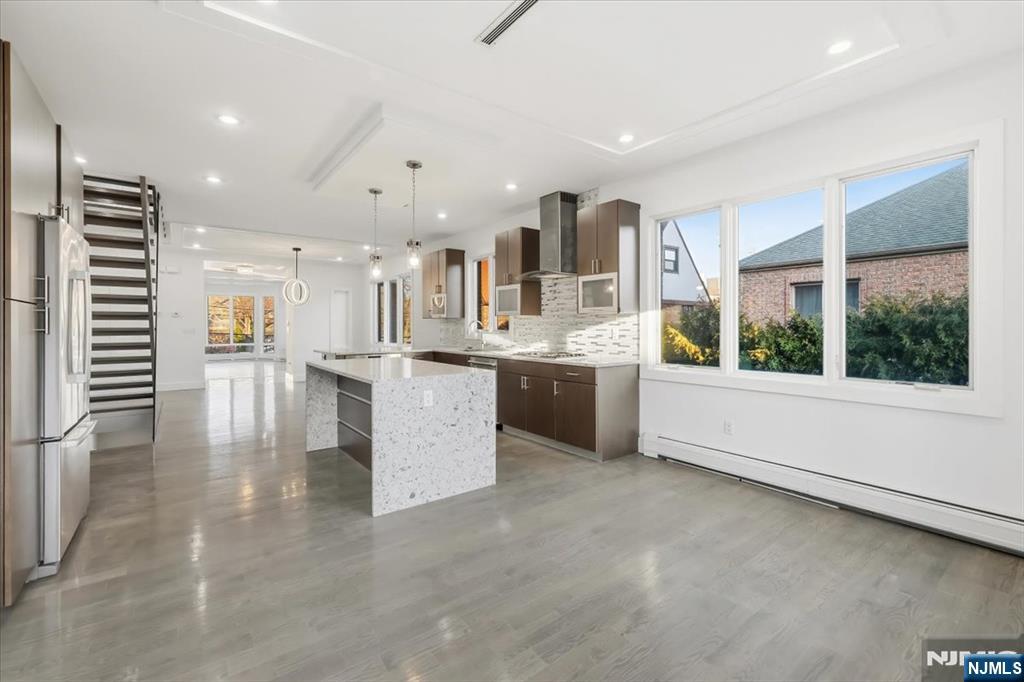 12 Orchard Street, Unit 12 Edgewater, NJ 07020 - Photo 2 of 33 a large white kitchen with a large window