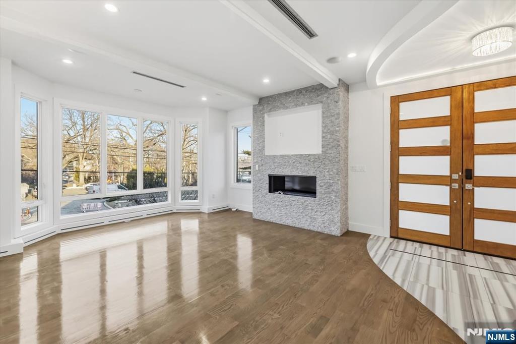 12 Orchard Street, Unit 12 Edgewater, NJ 07020 - Photo 22 of 33 a view of an empty room with a fireplace and a window