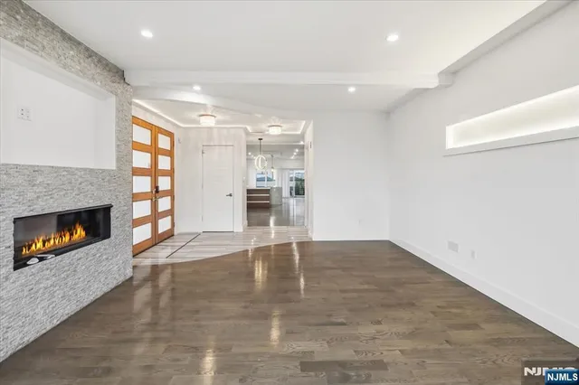 an empty room with windows and a fireplace