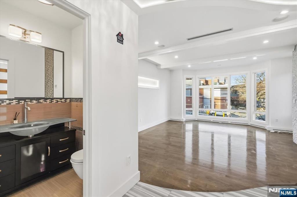 12 Orchard Street, Unit 12 Edgewater, NJ 07020 - Photo 28 of 33 a view of a bathroom with sink and mirror