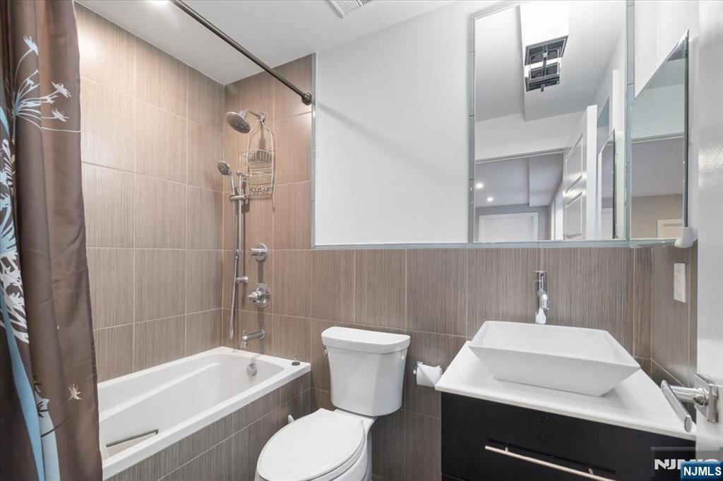 12 Orchard Street, Unit 12 Edgewater, NJ 07020 - Photo 6 of 33 a bathroom with a sink a toilet and shower