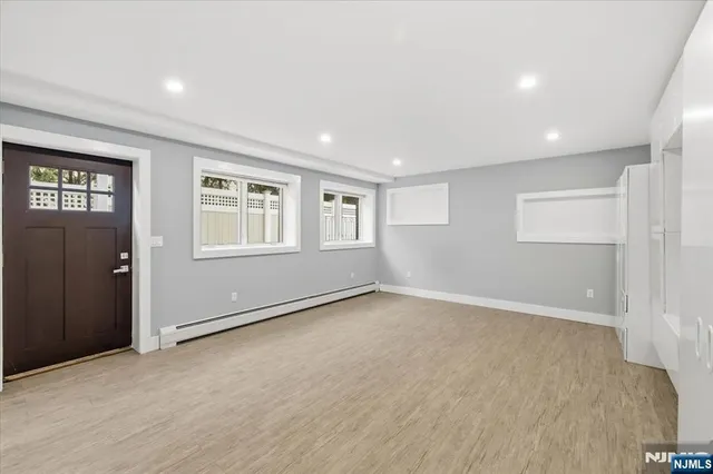 an empty room with windows and closet