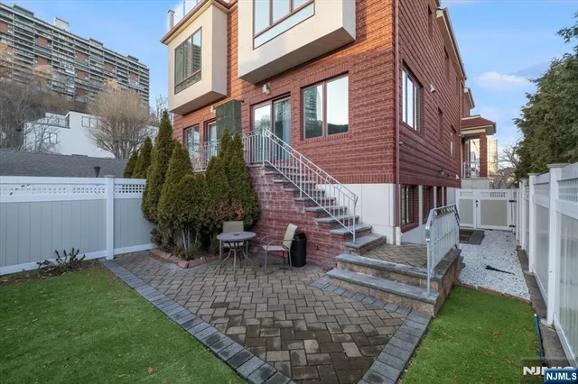 a view of a house with backyard and sitting area