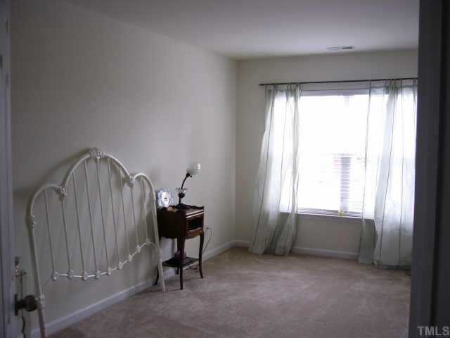 2220 Raven Road Raleigh, NC 27614 - Photo 7 of 8 a view of a bedroom with furniture and windows