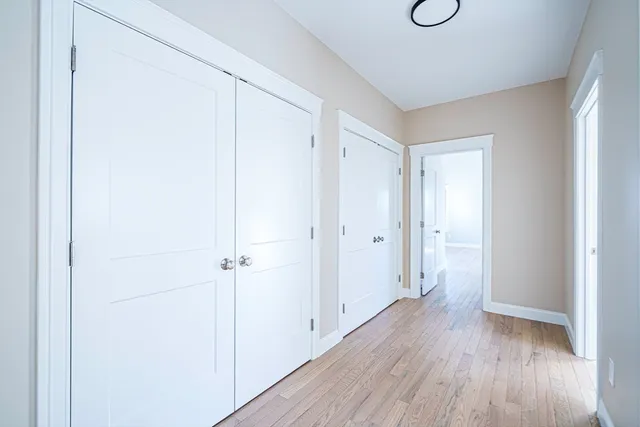 a view of a hallway with wooden floor