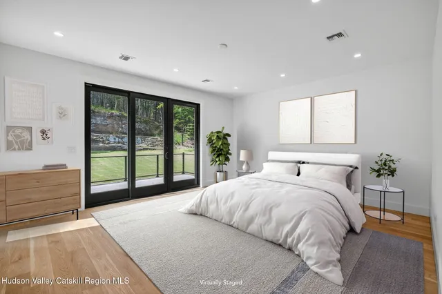 a spacious bedroom with a large bed and a large window