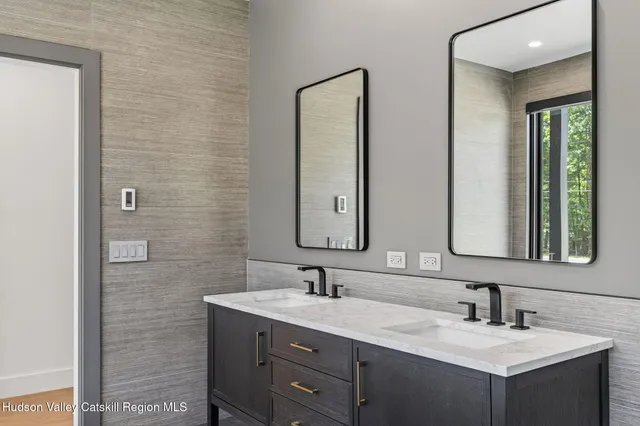 a bathroom with a double vanity sink mirror and a