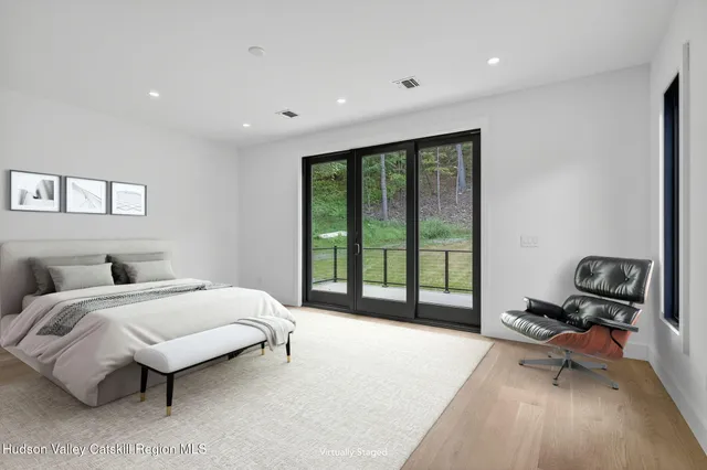 a spacious bedroom with a bed and a large window
