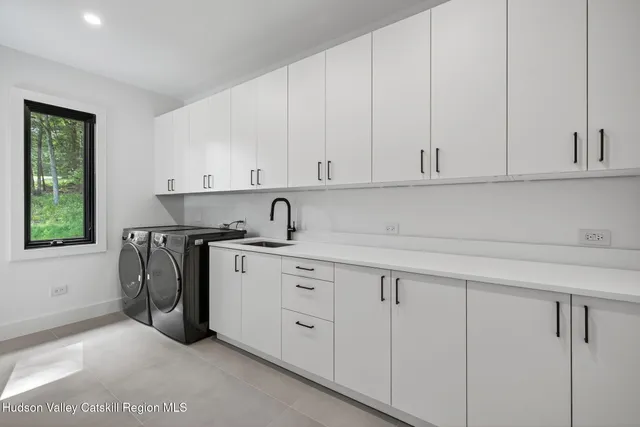 a kitchen with stainless steel appliances granite countertop a sink and a white cabinets