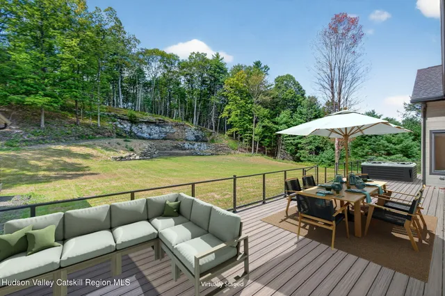 a view of a patio with couches potted plants and a swimming pool