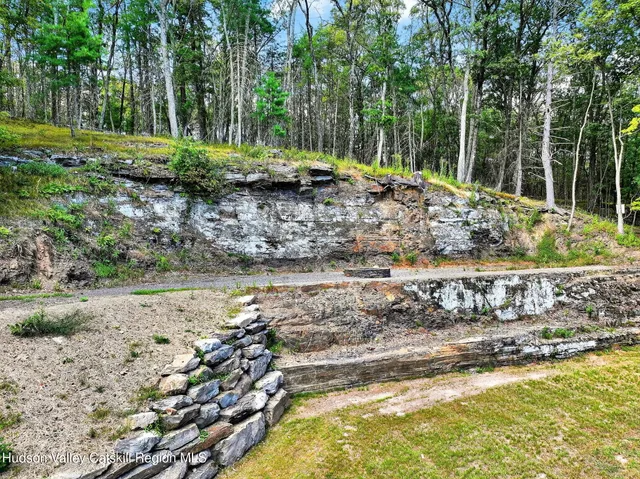 a view of a yard with wooden fence