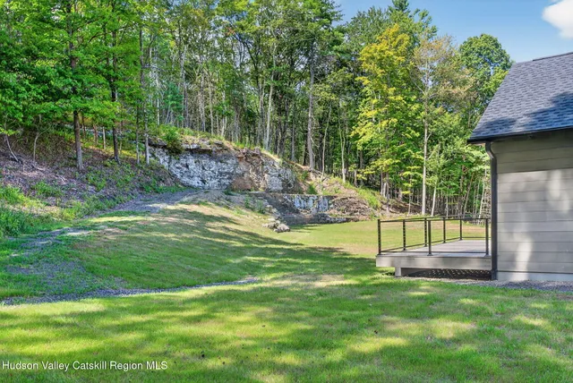 a view of a backyard with swimming pool