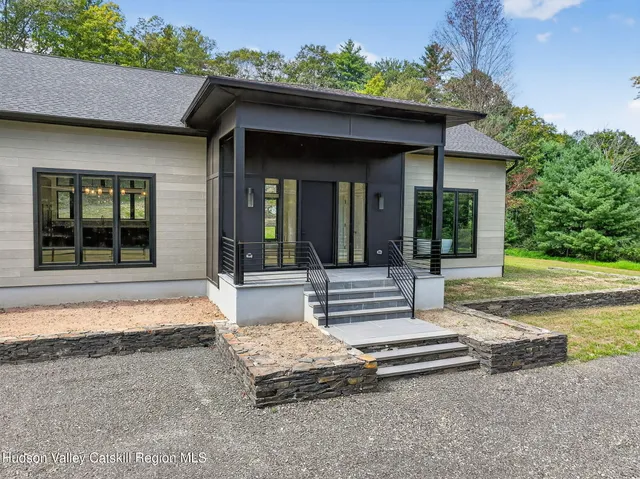 a view of a house with porch and sitting area