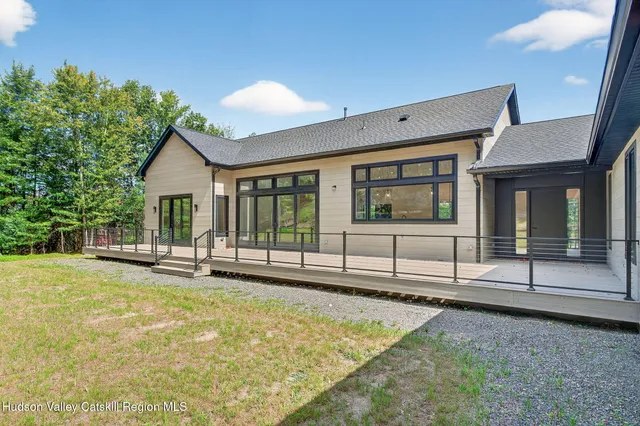 a view of a house with swimming pool and sitting area