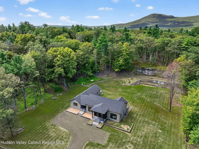 an aerial view of a house with garden space and street view