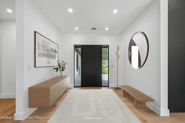 a living room with a large bed and a large mirror