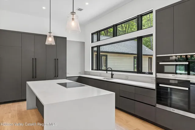 a kitchen with a stove a sink and a refrigerator