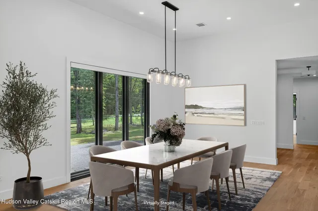 a view of a dining room with furniture window and wooden floor