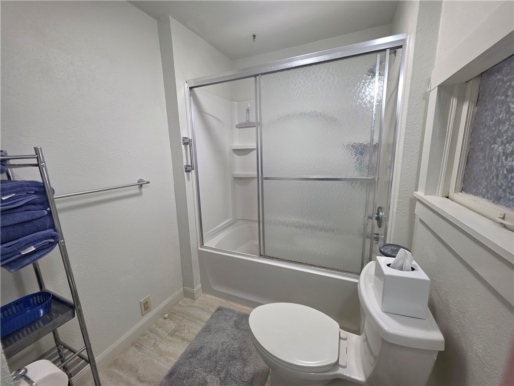 208 North 3rd Street Fulton, TX 78358 - Photo 14 of 23 a bathroom with a toilet and a shower