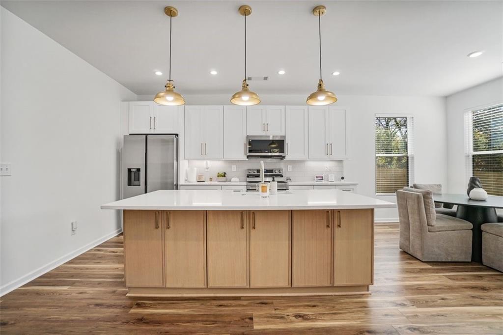 3510 Thompson Drive Northwest Atlanta, GA 30331 - Photo 16 of 28 a view of a kitchen with a sink a window and wooden floor