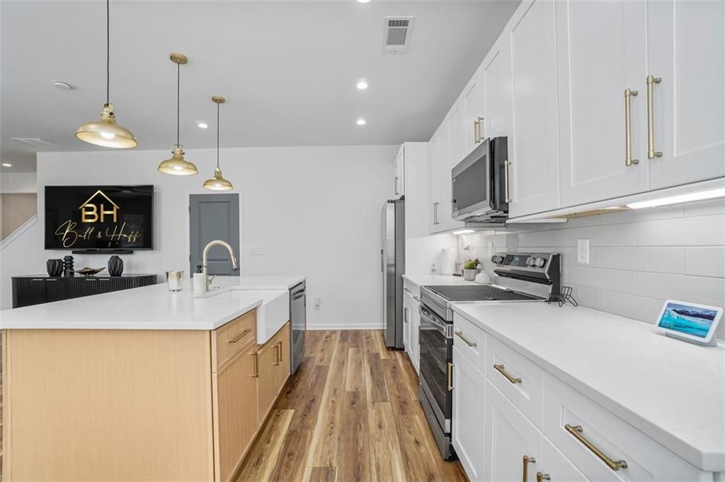 3510 Thompson Drive Northwest Atlanta, GA 30331 - Photo 18 of 28 a kitchen with a sink a stove and cabinets