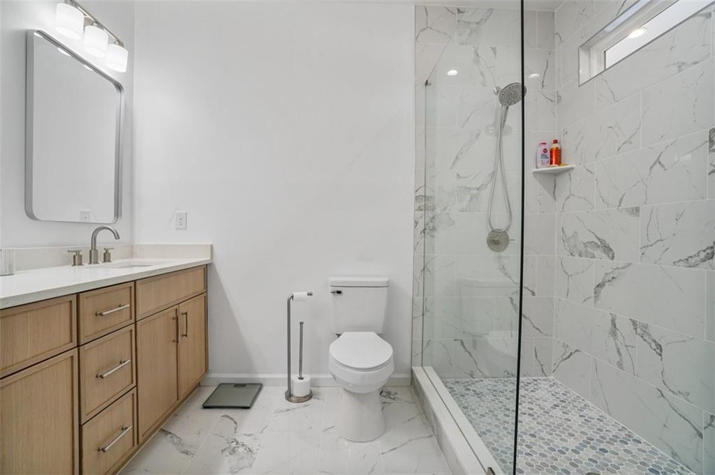 3510 Thompson Drive Northwest Atlanta, GA 30331 - Photo 10 of 28 a spacious bathroom with a shower sink mirror and toilet