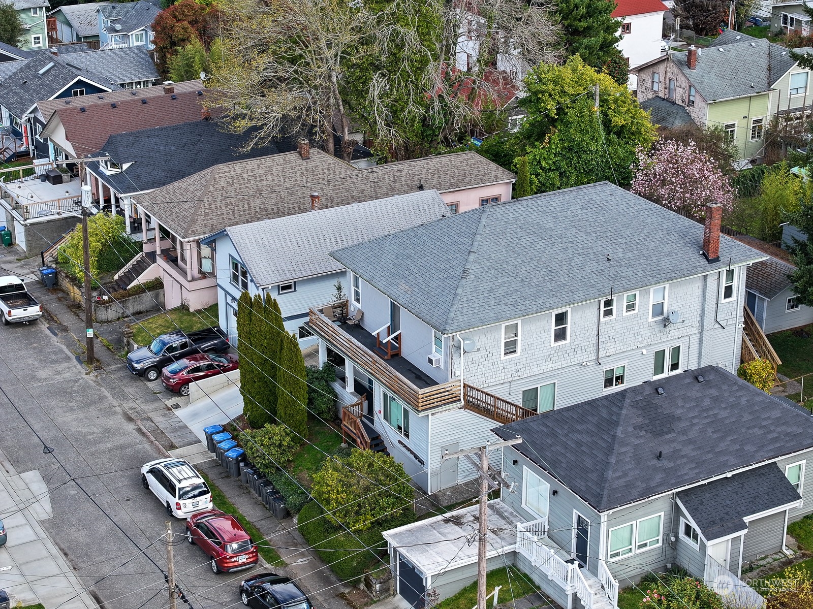 an aerial view of multiple houses with a yard