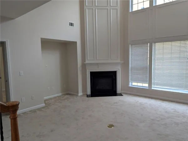a view of empty room with a fireplace