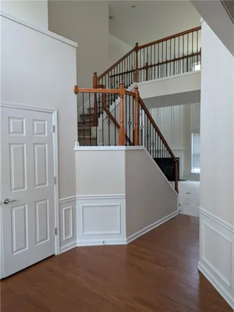 a view of staircase with white walls and a window