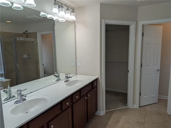 a bathroom with a sink double vanity and a mirror