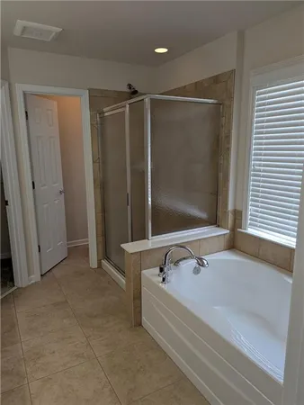 a bathroom with a tub and shower