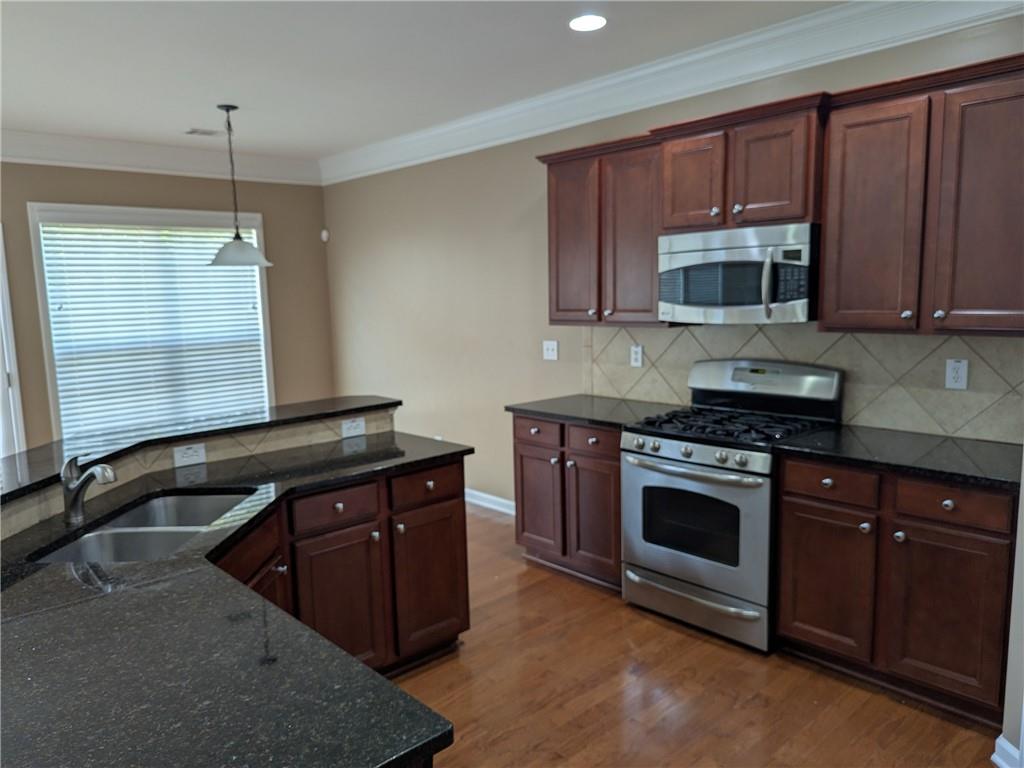 430 Floral Place Suwanee, GA 30024 - Photo 5 of 26 a kitchen with a sink stove and microwave
