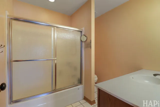 a bathroom with a shower and a sink