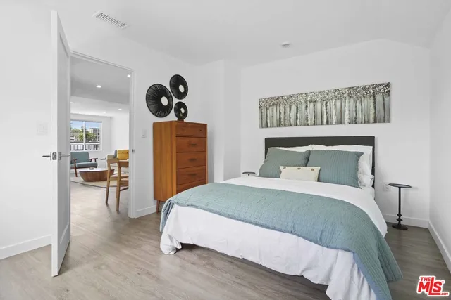 a bedroom with a bed and ceiling fan