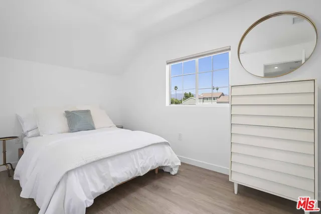 a bedroom with a bed and a mirror