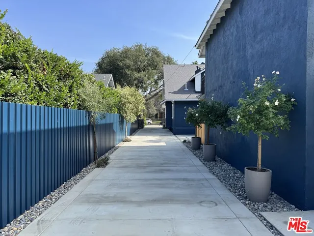 a view of a backyard with potted plants