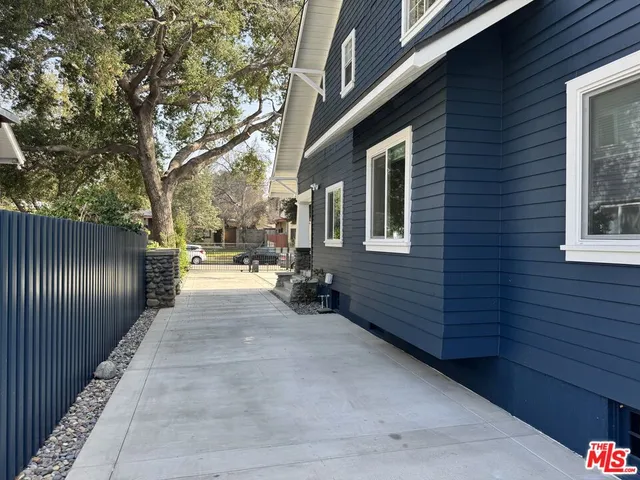 a view of a pathway both side of house