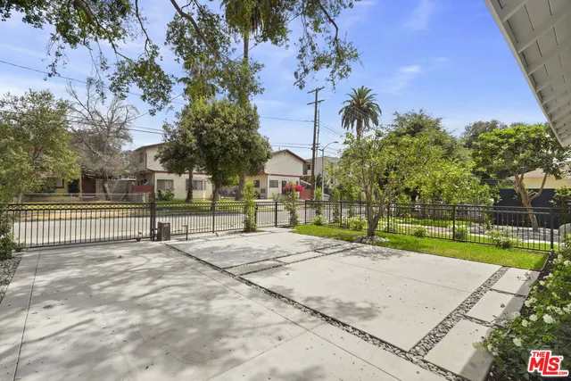 a sign board with flower garden in front of it