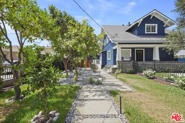 a front view of a house with garden and porch