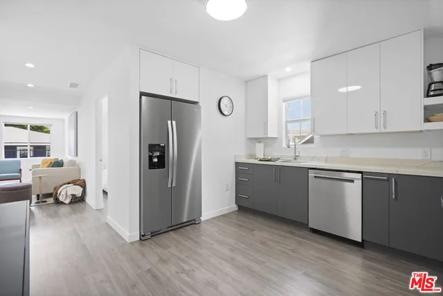 a kitchen with a refrigerator and a sink