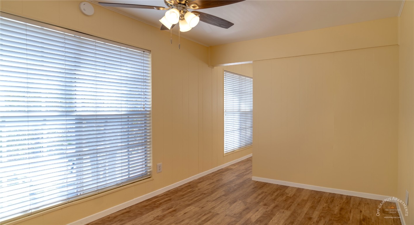 2108 San Gabriel Street, Unit 201 Austin, TX 78705 - Photo 3 of 15 a view of an empty room with a window and wooden floor